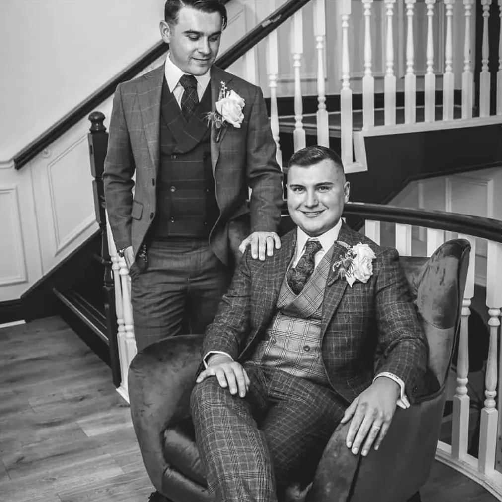 Two grooms in bespoke checked three-piece suits
