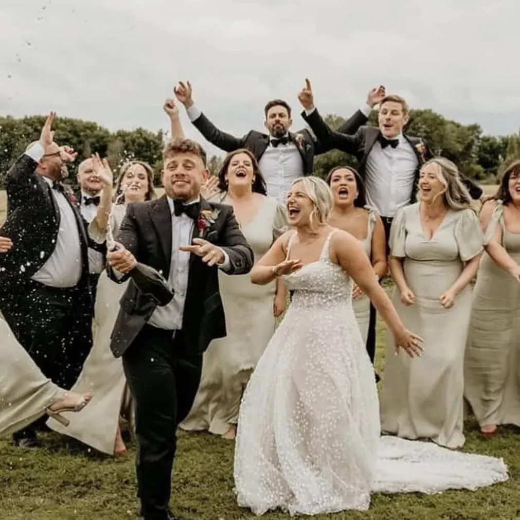 Wedding party celebrating, groom in a bespoke black tie dinner suit