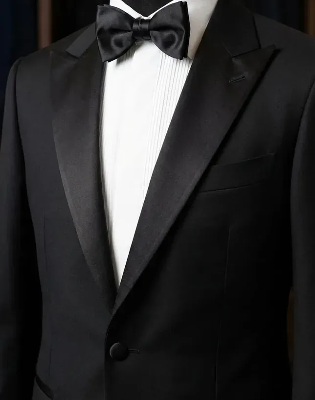Satin peak lapel and pleated dress shirt on a bespoke dinner jacket