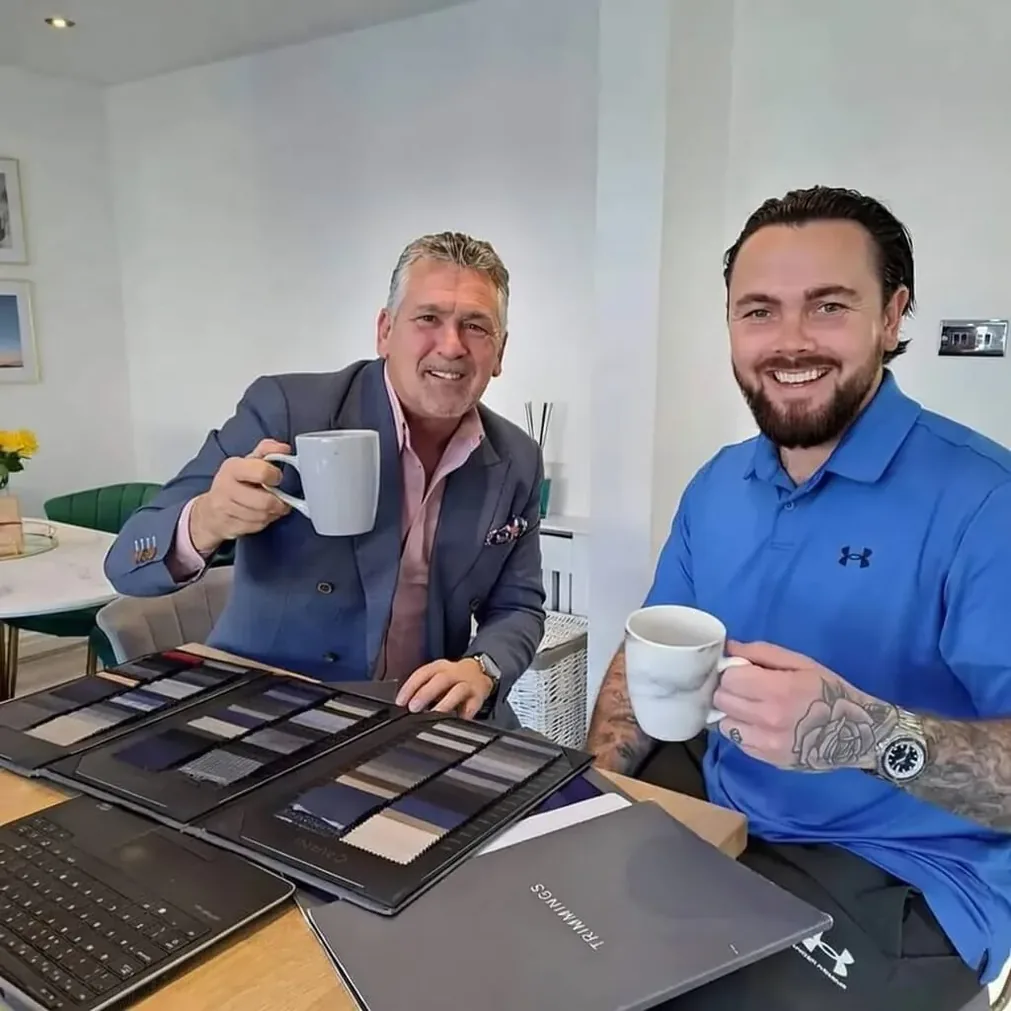 Noble Fox tailor and client choosing cloth at a home consultation