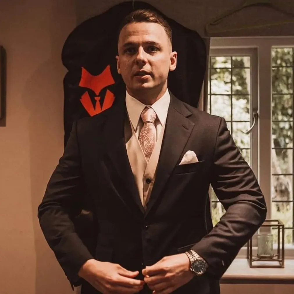 Groom in a bespoke dark suit before the ceremony