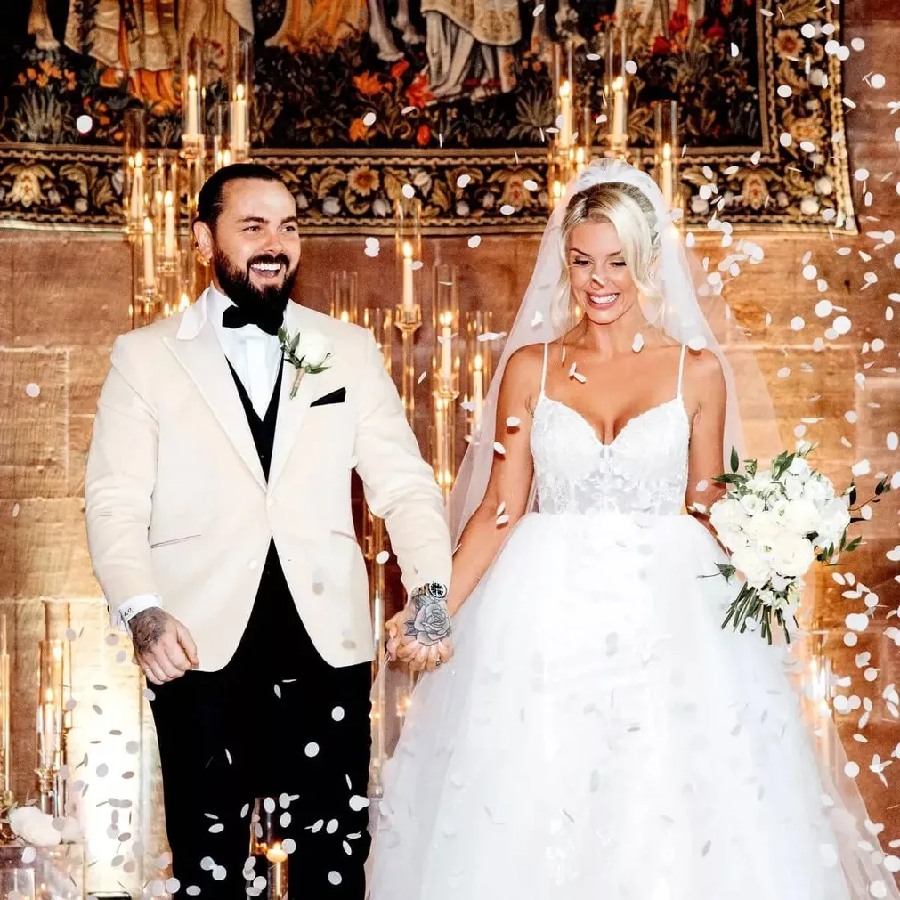 Groom in a bespoke ivory dinner jacket and black tie on his wedding day